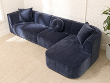 Load image into Gallery viewer, Bonnie three-piece sectional sofa in Amici Indigo blue upholstery with left-arm-facing loveseat, armless section, right-arm-facing chaise, and loose pillows


