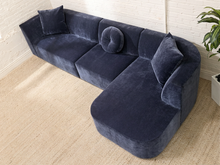 Load image into Gallery viewer, Bonnie three-piece sectional sofa in Amici Indigo blue upholstery with left-arm-facing loveseat, armless section, right-arm-facing chaise, and loose pillows

