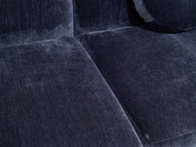 Load image into Gallery viewer, Close-up of a dark navy blue velvet sofa with textured fabric cushions and a matching round pillow.
