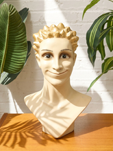 Load image into Gallery viewer, Vintage mannequin display head with stylized painted face, sculptural spiked hair, metallic gold finish, and neutral bust base
