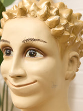 Load image into Gallery viewer, Close-up of a male mannequin head with a glossy gold spiky wig, beige skin, and dark brown eyebrows and eyes.

