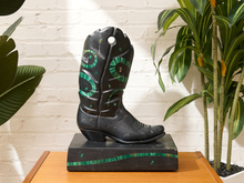 Load image into Gallery viewer, Vintage black cowboy boot sculpture with decorative green inlay-style patterns and geometric accents on a rectangular base
