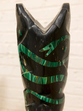 Load image into Gallery viewer, A close-up of a carved black wooden decorative object, likely a bowl or vase, featuring a green malachite inlay pattern, set against a light wood background.
