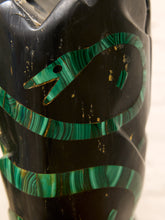Load image into Gallery viewer, Close-up of a black carved wooden vessel or container featuring bold green malachite inlay patterns and small gold accents.
