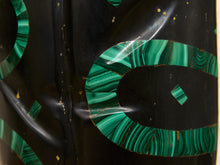 Load image into Gallery viewer, Close-up of a glossy black decorative object featuring bold green malachite-patterned inlay details.
