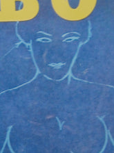 Load image into Gallery viewer, A close-up of a blue graphic print featuring a stylized line drawing of a female torso and face, with yellow lettering partially visible at the top.
