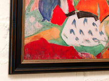 Load image into Gallery viewer, A close-up of a framed abstract painting hanging on a white textured wall. The artwork features bold, expressive brushstrokes in red, orange, green, blue, and white, enclosed in a black frame with a gold inner trim.
