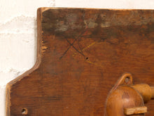 Load image into Gallery viewer, Close-up of a rustic wooden board with visible grain, scratches, and pencil markings, mounted against a white painted brick wall. Part of a wooden object is visible in the lower right corner.
