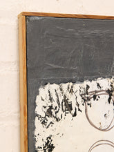 Load image into Gallery viewer, A close-up of a framed abstract painting with a thick light wood frame, featuring a dark charcoal gray upper section and a textured off-white lower section with black and gray brushstrokes.
