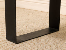Load image into Gallery viewer, Close-up of a black metal table leg with a square cross-section, resting on a beige textured carpet.
