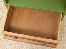 Load image into Gallery viewer, An open wooden drawer with a medium brown wood interior and a green painted drawer front, shown on a textured beige carpet.
