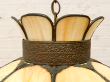 Load image into Gallery viewer, Close-up of a vintage stained glass pendant light featuring cream-colored glass panels and an ornate dark bronze metal band with embossed floral detailing.
