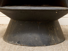 Load image into Gallery viewer, Close-up of a dark charcoal gray or black metal pedestal base with a wide flared circular top, resting on a beige woven rug.
