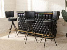 Load image into Gallery viewer, Vintage black upholstered bar with deep button tufting and brass-tone trim paired with three black swivel bar stools on metal bases
