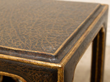 Load image into Gallery viewer, Close-up of a dark brown and gold table corner showing a textured, crackled finish on the top and frame.
