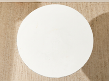 Load image into Gallery viewer, A round white coffee table top shown from a top-down view on a textured beige woven rug.
