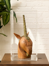 Load image into Gallery viewer, Carved wood unicorn head sculpture with ornate metallic spiral horn displayed inside a clear rectangular acrylic case
