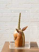 Load image into Gallery viewer, Carved wood unicorn head sculpture with ornate metallic spiral horn displayed inside a clear rectangular acrylic case
