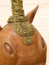 Load image into Gallery viewer, Close-up of a carved wooden animal head sculpture with ornate metallic gold decorative headpiece and engraved details, set against a light neutral background.

