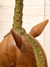 Load image into Gallery viewer, Close-up of a wooden instrument, likely a traditional lute or similar stringed musical instrument, showing a polished brown wood body, ornate gold-toned metal neck, and decorative gold trim.
