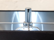 Load image into Gallery viewer, Close-up of a polished chrome metal lamp post and horizontal support bar, set against a reflective dark surface with a light beige background.
