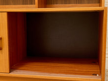 Load image into Gallery viewer, Close-up of an open wooden cabinet or shelf compartment with a warm medium-brown wood finish and dark interior lining.

