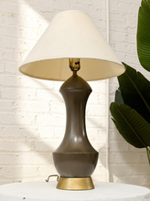 Load image into Gallery viewer, Vintage table lamp with tall sculptural charcoal-brown curving body, round brass-tone base, and oversized off-white tapered fabric shade
