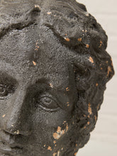 Load image into Gallery viewer, Close-up of a dark textured sculpture or decorative head with distressed beige patches, photographed against a light neutral background.
