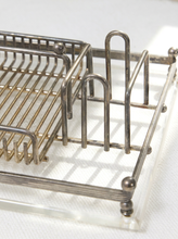 Load image into Gallery viewer, A close-up of a silver metal wire dish rack with a clear acrylic base, shown on a white textured surface.
