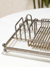 Load image into Gallery viewer, A close-up of a silver metal wire dish rack with a slotted tray, resting on a white textured surface.
