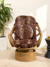 Load image into Gallery viewer, Vintage tiki bamboo lounge chair with leopard print upholstered seat and back, curved bamboo arms, and rounded woven base
