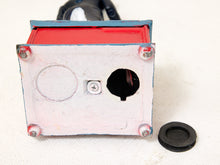 Load image into Gallery viewer, A small painted metal electrical box or control module with a white front face, red top panel, blue side trim, visible screws, a black cable entering from the top, and a separate black rubber gasket placed beside it on a light fabric background.
