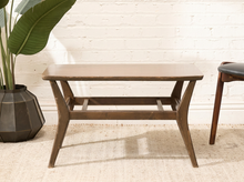 Load image into Gallery viewer, Vintage rectangular table with woodgrain Formica top, rounded corners, dark wood base, angled legs, and horizontal supports
