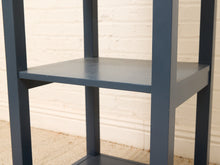 Load image into Gallery viewer, Vintage navy blue wooden display shelf featuring four open storage levels, a compact vertical silhouette, and a classic painted finish.
