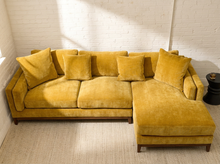 Load image into Gallery viewer, Lisette Sofa with Chaise in Sacramento Honey featuring golden mustard upholstery, plush seat cushions, coordinating pillows, wide arms, and wood legs

