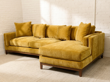 Load image into Gallery viewer, Lisette Sofa with Chaise in Sacramento Honey featuring golden mustard upholstery, plush seat cushions, coordinating pillows, wide arms, and wood legs

