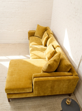 Load image into Gallery viewer, Lisette Sofa with Chaise in Sacramento Honey featuring golden mustard upholstery, plush seat cushions, coordinating pillows, wide arms, and wood legs

