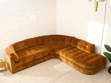 Load image into Gallery viewer, Prima curved sectional sofa in Thriller Amber with golden amber upholstery, deep button-tufted seats, channel-tufted back cushions, and rounded silhouette
