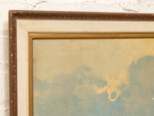 Load image into Gallery viewer, Close-up of a framed artwork corner showing a brown textured frame, a wide off-white mat, a gold inner frame, and a muted blue and beige painted surface against a white brick wall.
