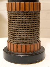Load image into Gallery viewer, A close-up of a cylindrical mesh filter or air filter with a brown pleated top and bottom and a black base, set against a light beige background.
