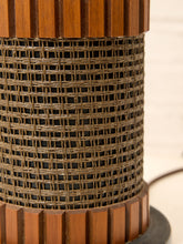 Load image into Gallery viewer, Close-up of a cylindrical woven rattan or wicker lampshade with fluted medium-brown wooden side panels, shown against a light neutral background.
