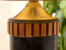Load image into Gallery viewer, Close-up detail of a vintage table lamp base featuring a polished gold metal top, a fluted bronze collar, and a black cylindrical body.
