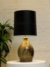 Load image into Gallery viewer, Vintage table lamp with rounded earthy brown and gray drip-glaze base and large black drum shade
