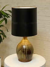 Load image into Gallery viewer, Vintage table lamp with rounded earthy brown and gray drip-glaze base and large black drum shade
