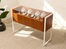 Load image into Gallery viewer, Danish modern wood jewelry display case with clear glass top, multiple shallow drawers, and squared metal frame and legs
