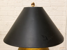 Load image into Gallery viewer, A black conical lampshade with a small brass finial on top, set against a white painted brick wall background.
