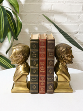 Load image into Gallery viewer, Pair of vintage brass Abraham Lincoln bust bookends with detailed profiles, period clothing, warm patina, and stepped bases
