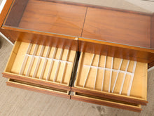 Load image into Gallery viewer, A close-up of a wooden storage cabinet or organizer with two open drawers. The drawers contain light-colored wooden dividers arranged in grid-like compartments.
