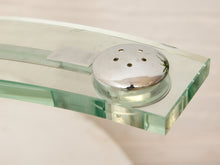 Load image into Gallery viewer, A close-up of a modern glass shower head with a polished chrome round control knob on a clear glass arm, set against a soft beige background.
