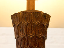 Load image into Gallery viewer, Close-up of a carved wooden decorative object with a warm brown finish and a light wood cylindrical post extending upward, set against a softly blurred cream and white background.
